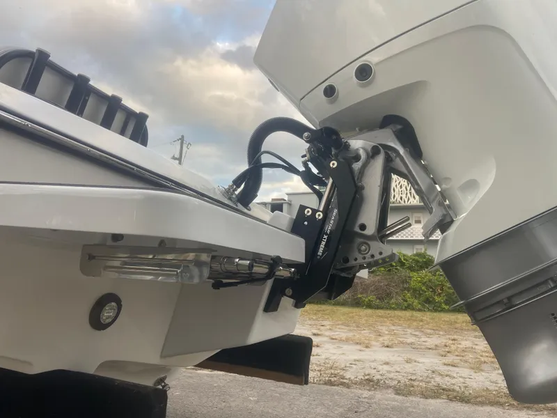 Slide: The Image of 1987 Paramount 21 boat with outboard motor, close-up view. - 29