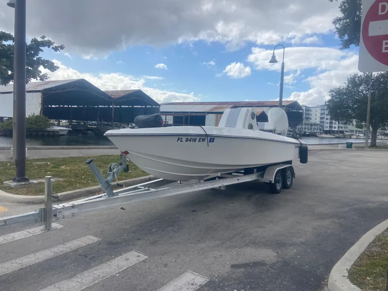 Slide: The Image of 1987 Paramount 21 boat on trailer at marina parking lot. - 3