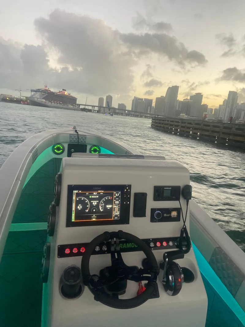 Slide: The Image of 1987 Paramount 21 boat dashboard with city skyline and cruise ship in background. - 4
