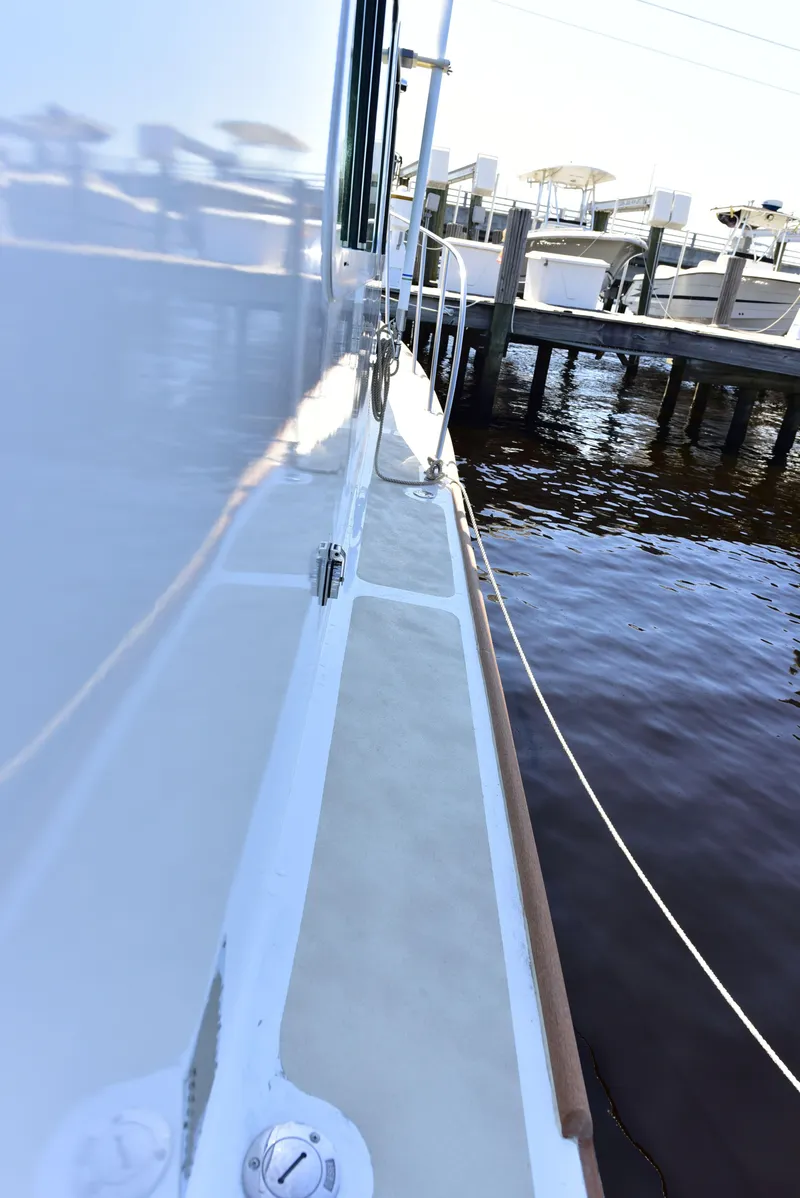 Slide: The Image of 1998 Duffy 35 Downeast Cruiser docked by the water. - 16