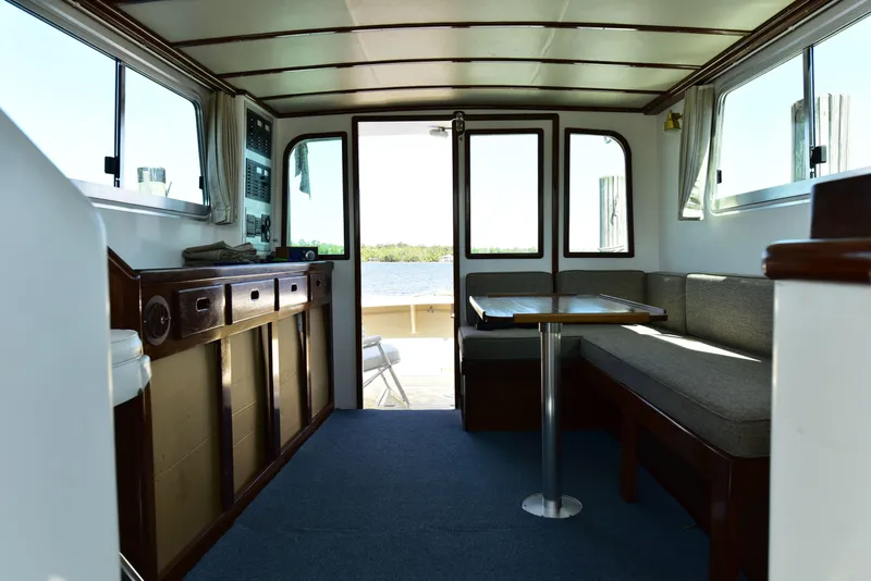 Slide: The Image of Interior of 1998 Duffy 35 Downeast Cruiser with seating and table, overlooking water. - 21