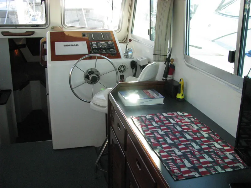 Slide: The Image of Interior of 1998 Duffy 35 Downeast Cruiser with steering wheel and control panel. - 29