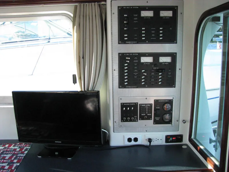 Slide: The Image of Control panel and monitor inside 1998 Duffy 35 Downeast Cruiser boat cabin. - 34