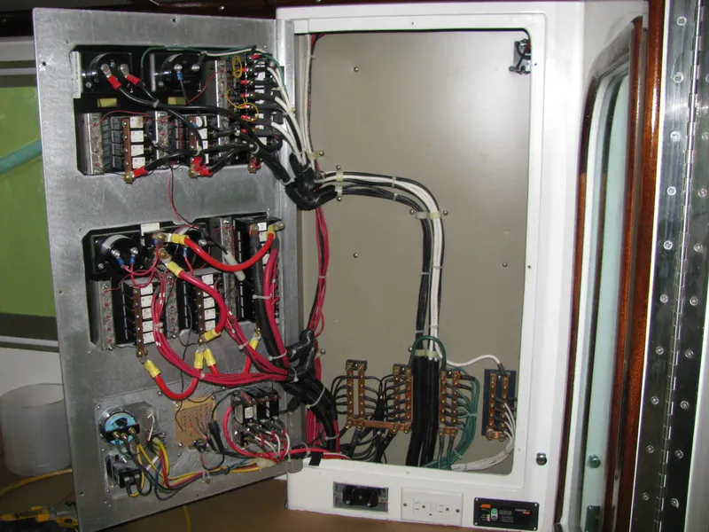 Slide: The Image of Electrical panel inside a 1998 Duffy 35 Downeast Cruiser, showcasing wiring and circuit components. - 36