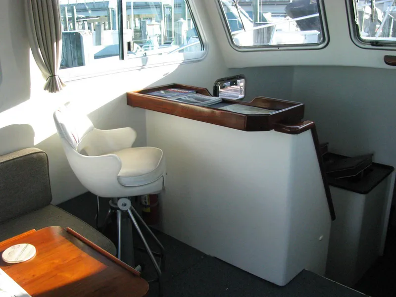 Slide: The Image of Interior of 1998 Duffy 35 Downeast Cruiser with helm station and seating area. - 37