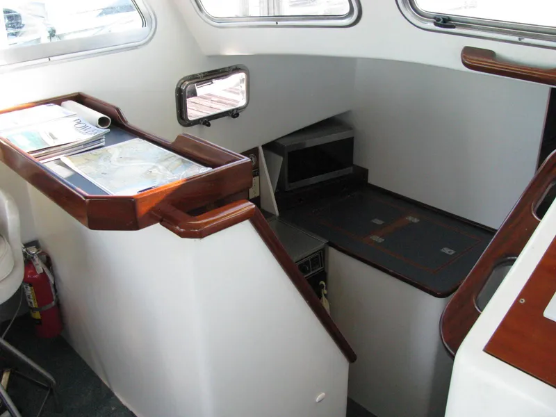 Slide: The Image of Interior of 1998 Duffy 35 Downeast Cruiser with navigation area and stairs. - 38