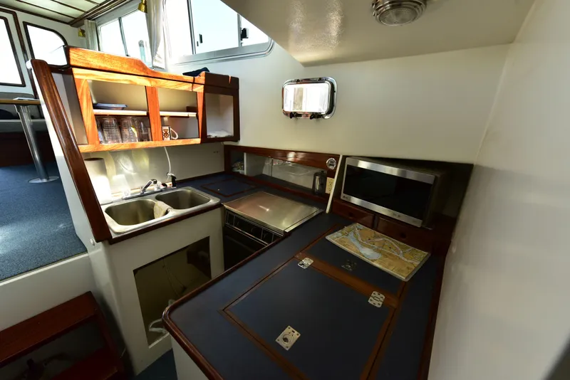 Slide: The Image of 1998 Duffy 35 Downeast Cruiser galley with sink, stove, and microwave. - 39