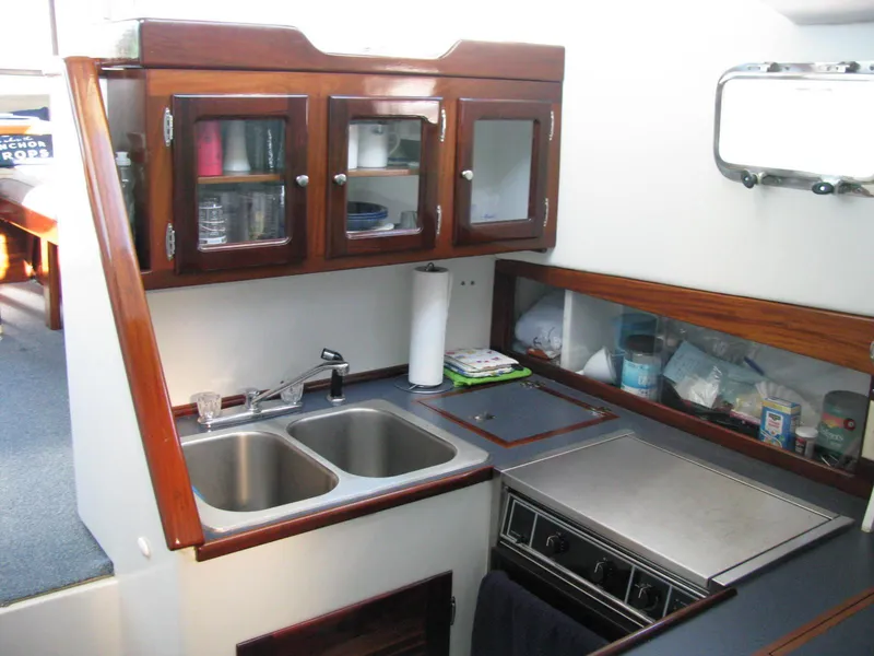 Slide: The Image of Compact kitchen in 1998 Duffy 35 Downeast Cruiser with dual sinks and wooden cabinets. - 40