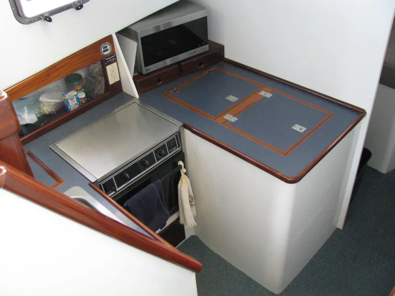 Slide: The Image of Compact kitchen area in a 1998 Duffy 35 Downeast Cruiser boat. - 42