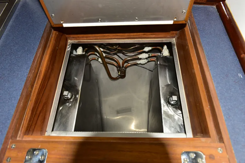 Slide: The Image of Engine compartment of 1998 Duffy 35 Downeast Cruiser with visible wiring and metal components. - 43