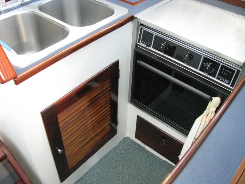 Slide: The Image of 1998 Duffy 35 Downeast Cruiser kitchen with double sink and built-in oven. - 44