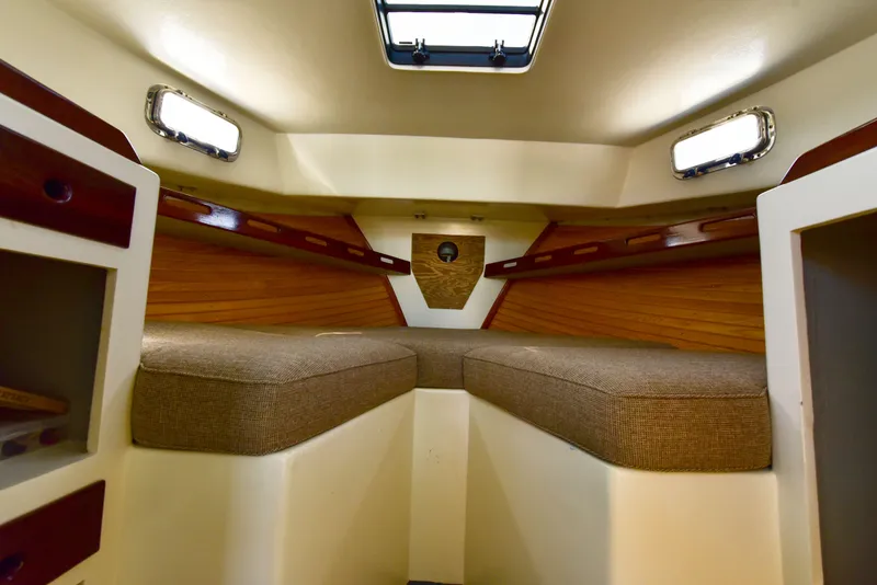 Slide: The Image of 1998 Duffy 35 Downeast Cruiser cabin interior with cozy seating and wood accents. - 45