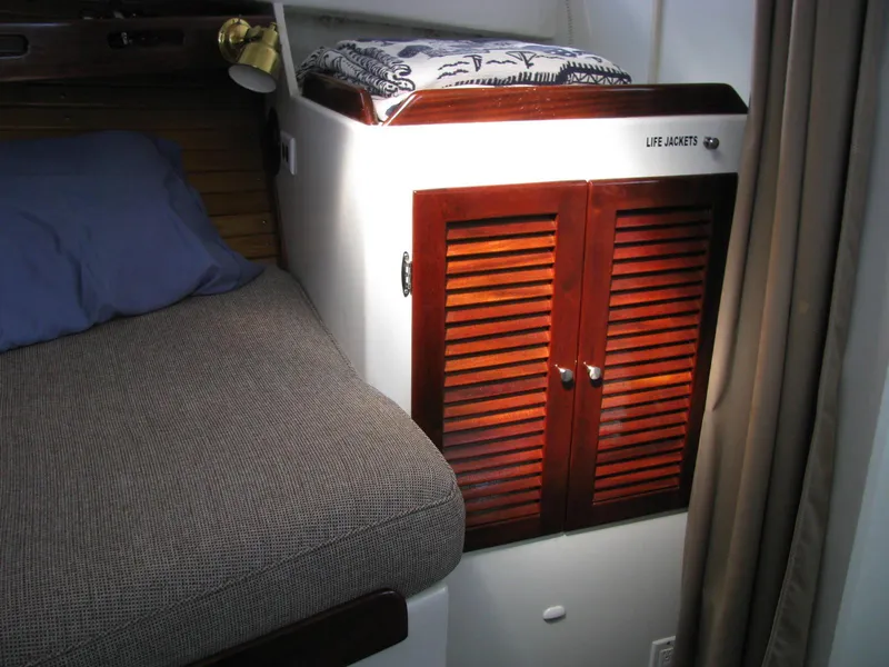Slide: The Image of Cozy cabin interior of 1998 Duffy 35 Downeast Cruiser with wooden storage and bedding. - 47
