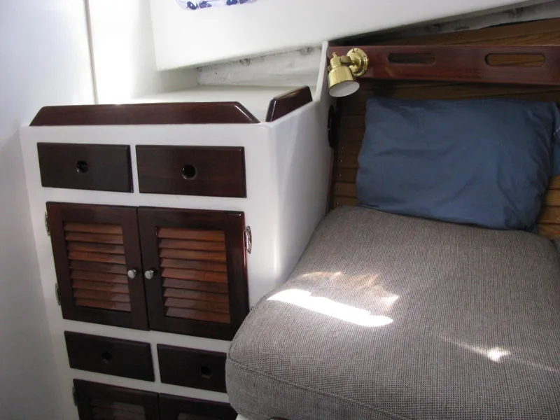 Slide: The Image of Cozy cabin interior of 1998 Duffy 35 Downeast Cruiser with bed and wooden storage. - 48
