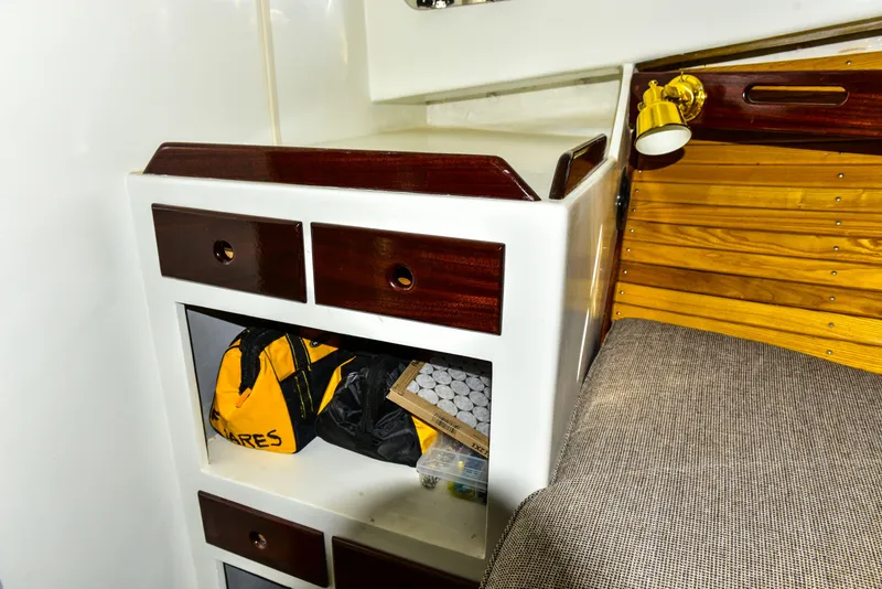 Slide: The Image of Interior of 1998 Duffy 35 Downeast Cruiser with storage drawers and cozy seating. - 49