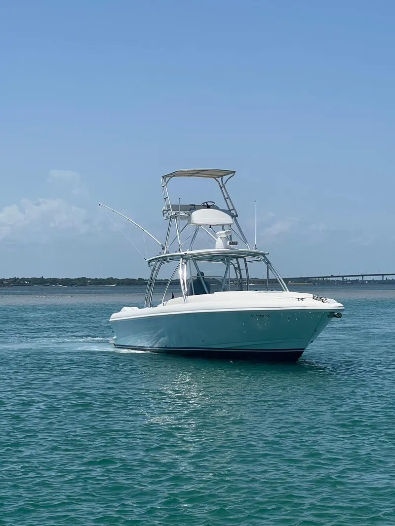 Slide: The Image of 2001 Intrepid 366 Cuddy boat cruising on clear blue water. - 0