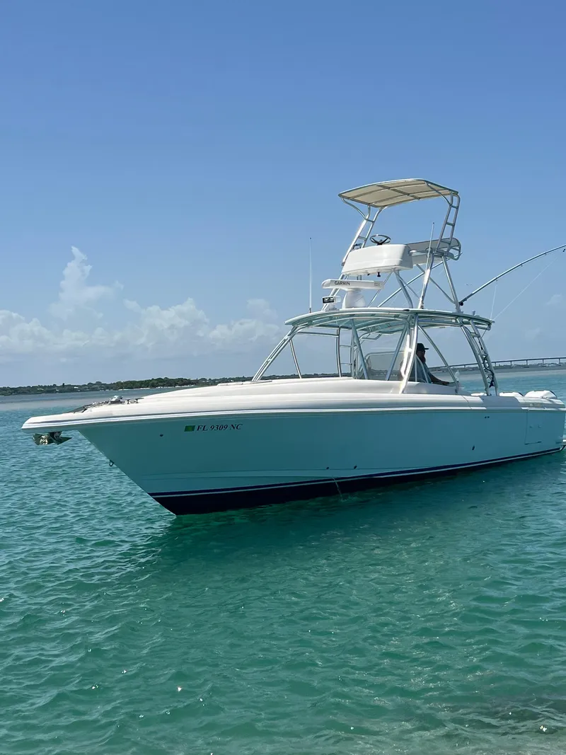Slide: The Image of 2001 Intrepid 366 Cuddy boat on clear blue water under a sunny sky. - 1