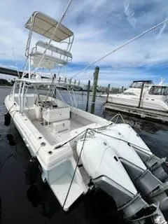 Slide: The Image of 2001 Intrepid 366 Cuddy boat docked with dual outboard engines. - 16