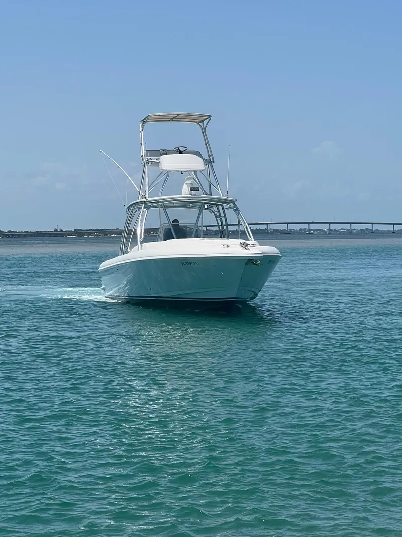 Slide: The Image of 2001 Intrepid 366 Cuddy boat cruising on clear blue water. - 2