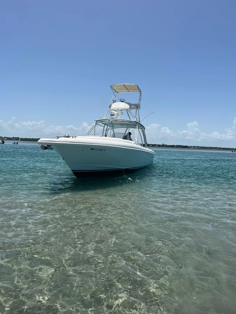 Slide: The Image of 2001 Intrepid 366 Cuddy boat on clear blue water under sunny sky. - 23