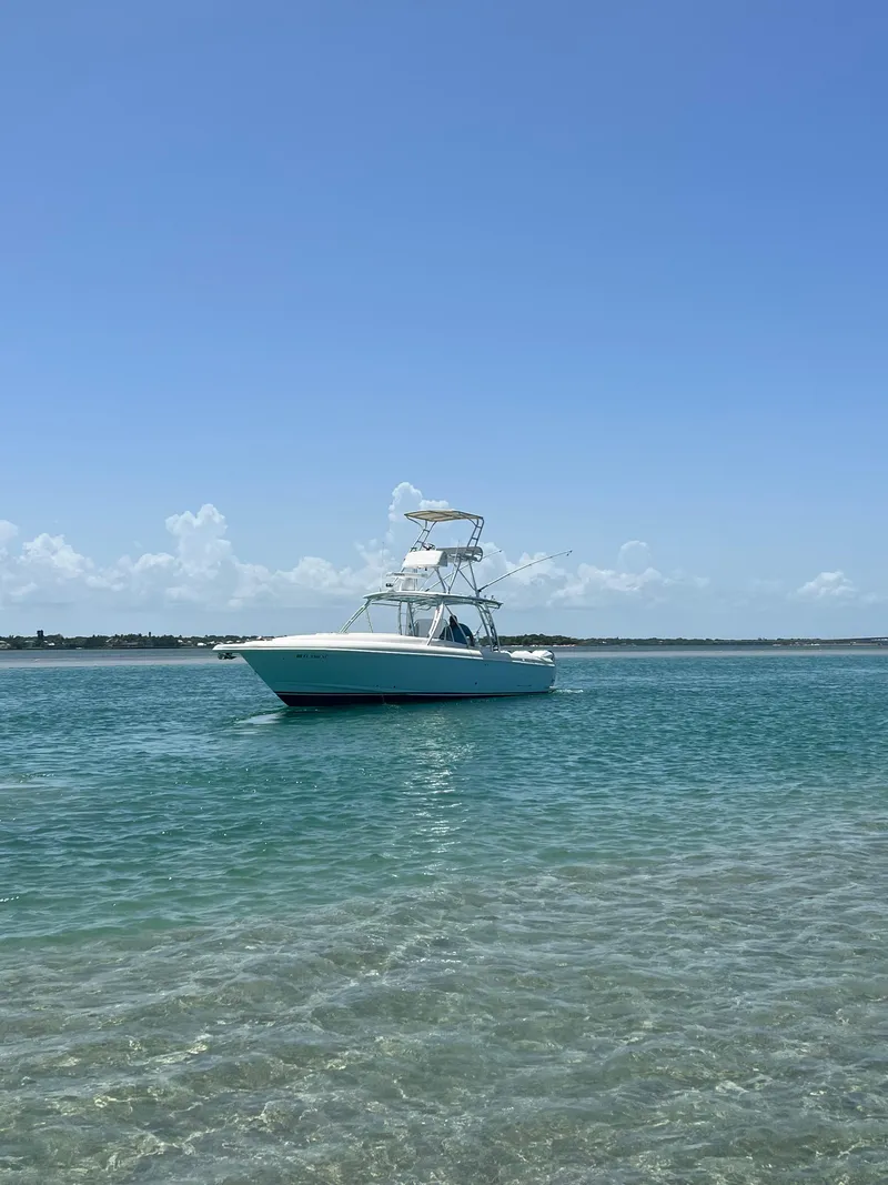 Slide: The Image of 2001 Intrepid 366 Cuddy boat on clear blue water under a sunny sky. - 24