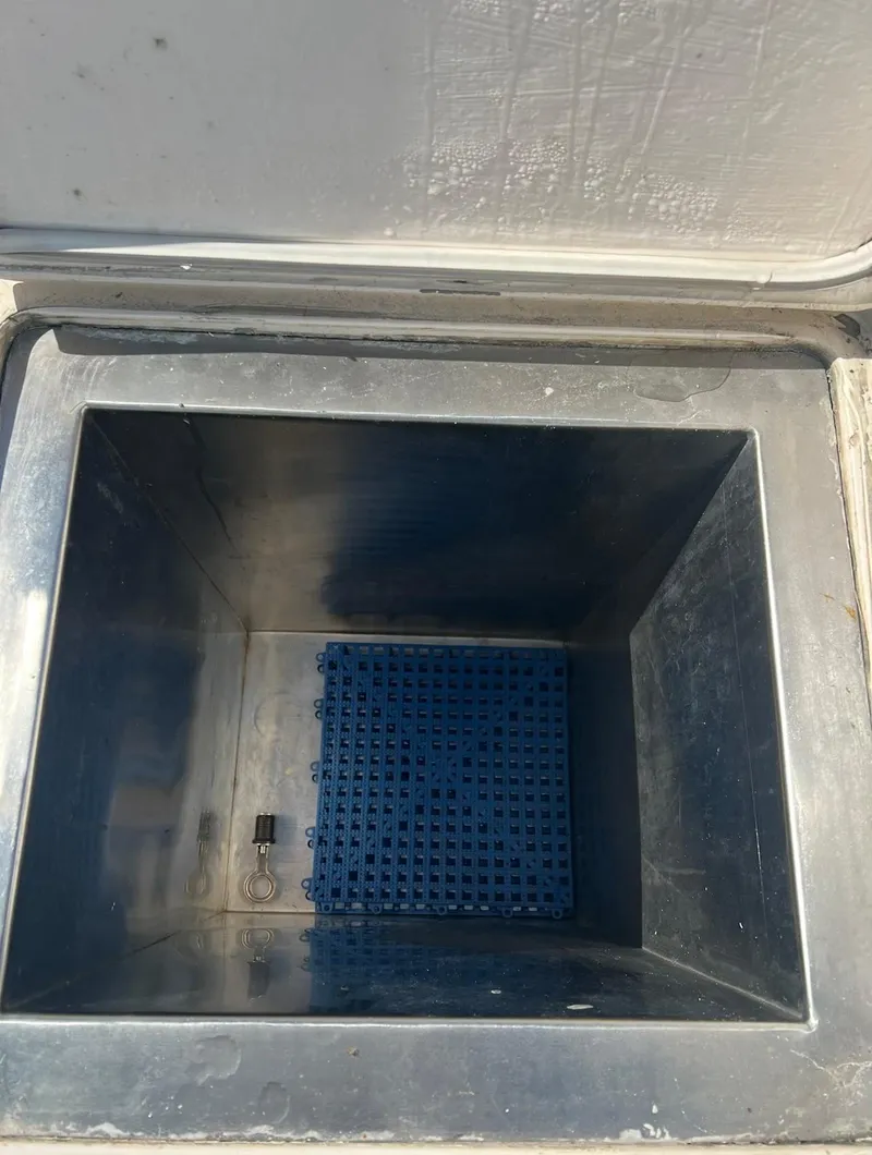Slide: The Image of Open storage compartment in 2001 Intrepid 366 Cuddy boat. - 27