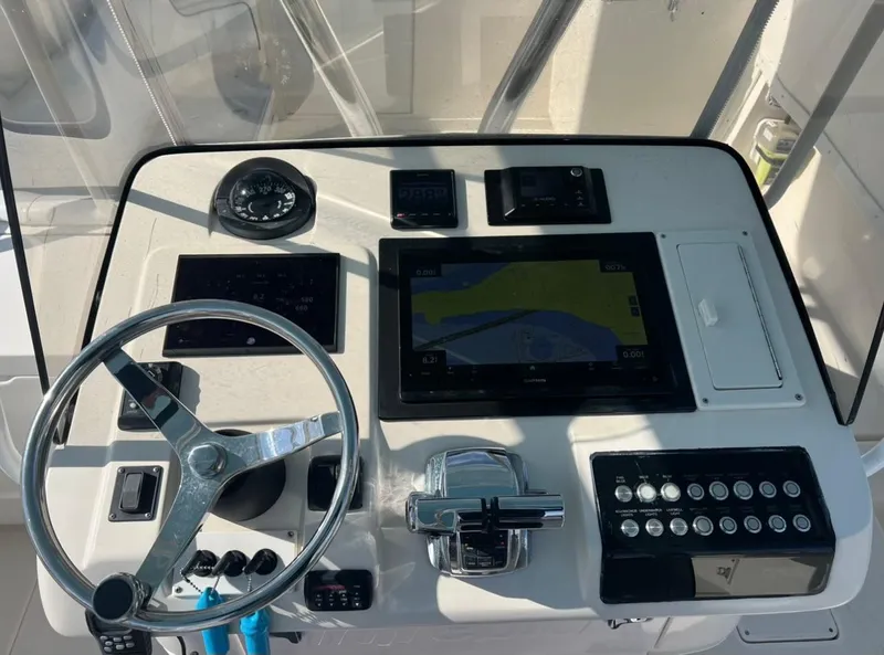 Slide: The Image of 2001 Intrepid 366 Cuddy helm with steering wheel and navigation controls. - 28