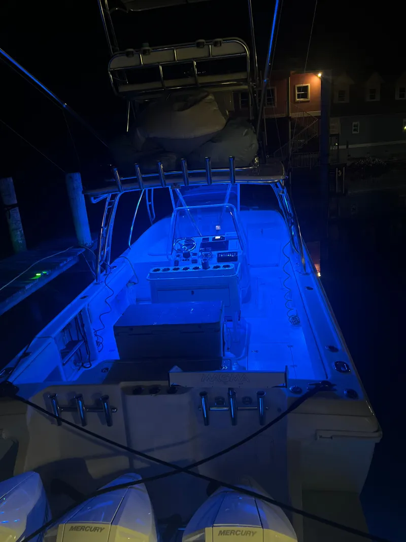 Slide: The Image of 2001 Intrepid 366 Cuddy boat illuminated with blue lights at night. - 3