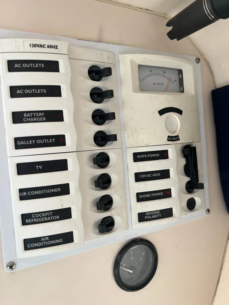 Slide: The Image of Electrical panel of a 2001 Intrepid 366 Cuddy boat with labeled switches and gauges. - 30