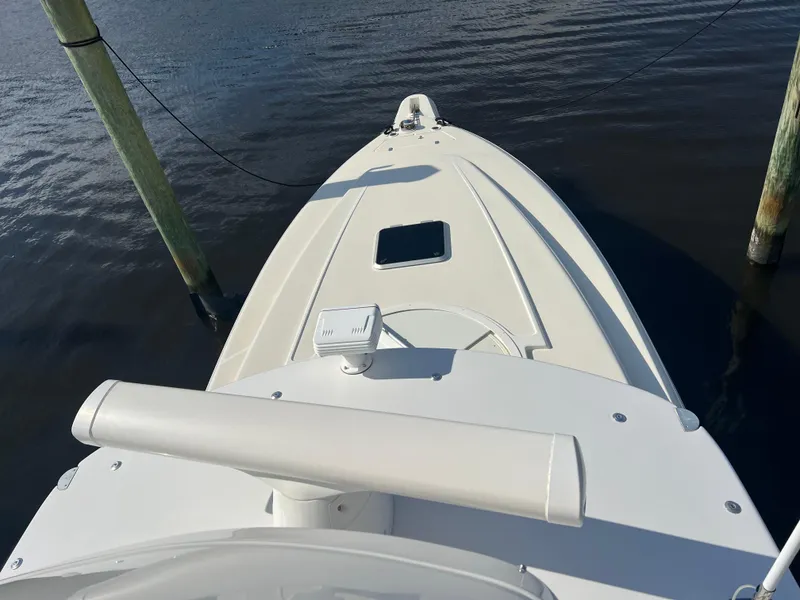 Slide: The Image of 2001 Intrepid 366 Cuddy boat docked on calm water. - 33