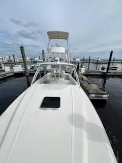 Slide: The Image of 2001 Intrepid 366 Cuddy boat docked at marina under cloudy sky. - 6