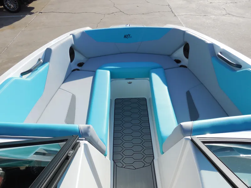 Slide: The Image of 2025 MasterCraft NXT24 boat interior with blue and gray seating. - 10