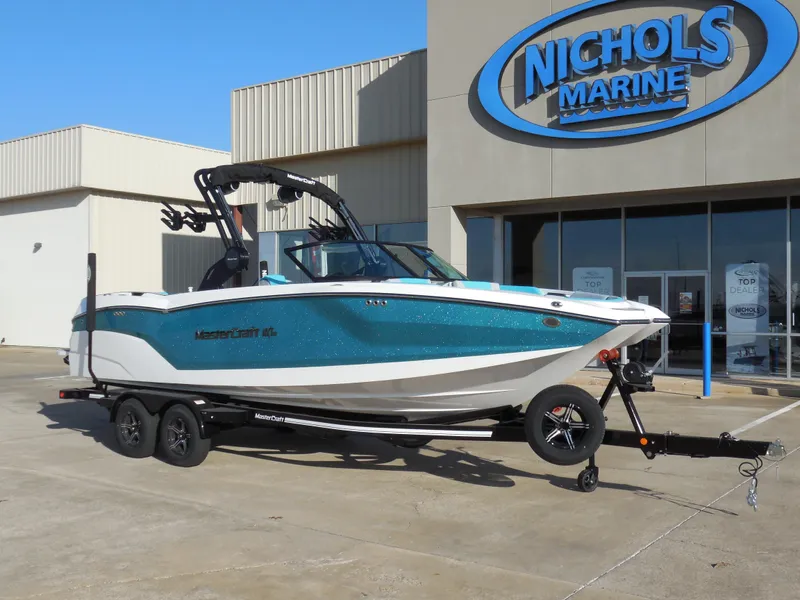Slide: The Image of 2025 MasterCraft NXT24 boat at Nichols Marine dealership. - 2
