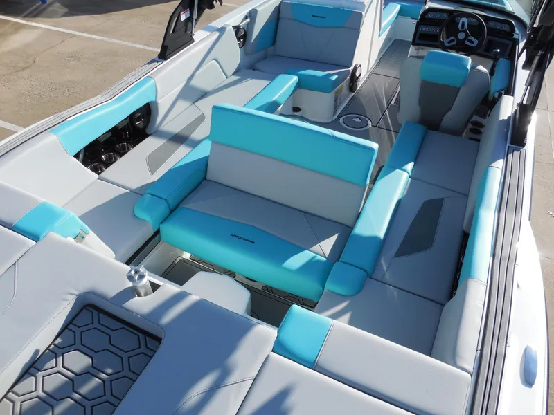 Slide: The Image of 2025 MasterCraft NXT24 boat interior with turquoise and gray seating. - 7