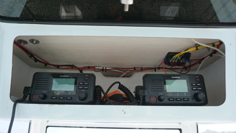 Slide: The Image of 2023 Pair Customs 25 Center Console with dual Garmin marine radios. - 10