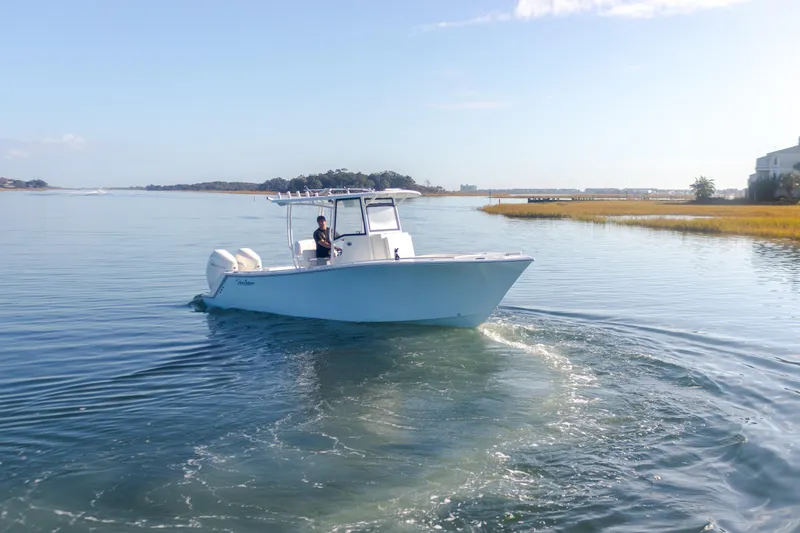 Slide: The Image of 2023 Pair Customs 25 Center Console boat cruising on calm waters. - 3