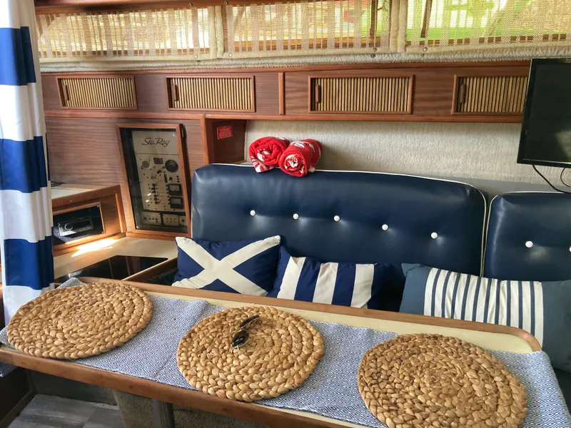 Slide: The Image of Interior of 1986 Sea Ray 340 Express Cruiser with nautical decor and woven placemats. - 17