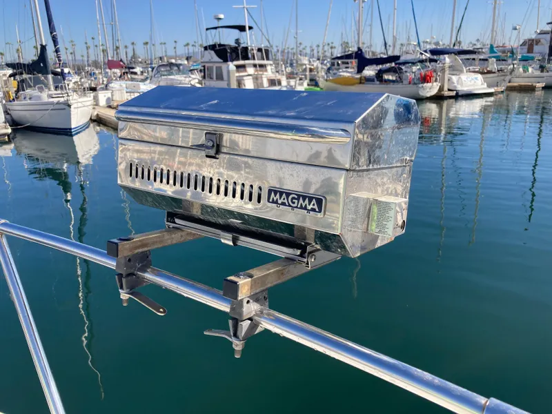 Slide: The Image of Magma grill mounted on 1986 Sea Ray 340 Express Cruiser, docked in a marina. - 25