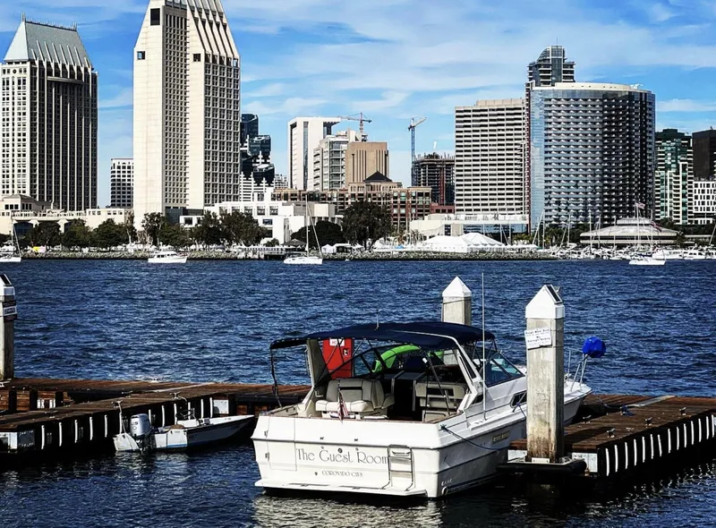 Slide: The Image of 1986 Sea Ray 340 Express Cruiser docked with city skyline in background. - 31