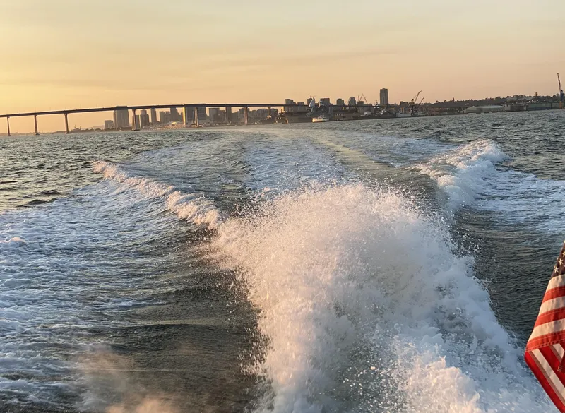 Slide: The Image of Sea Ray 340 Express Cruiser, 1986, cruising with city skyline and bridge in background. - 32