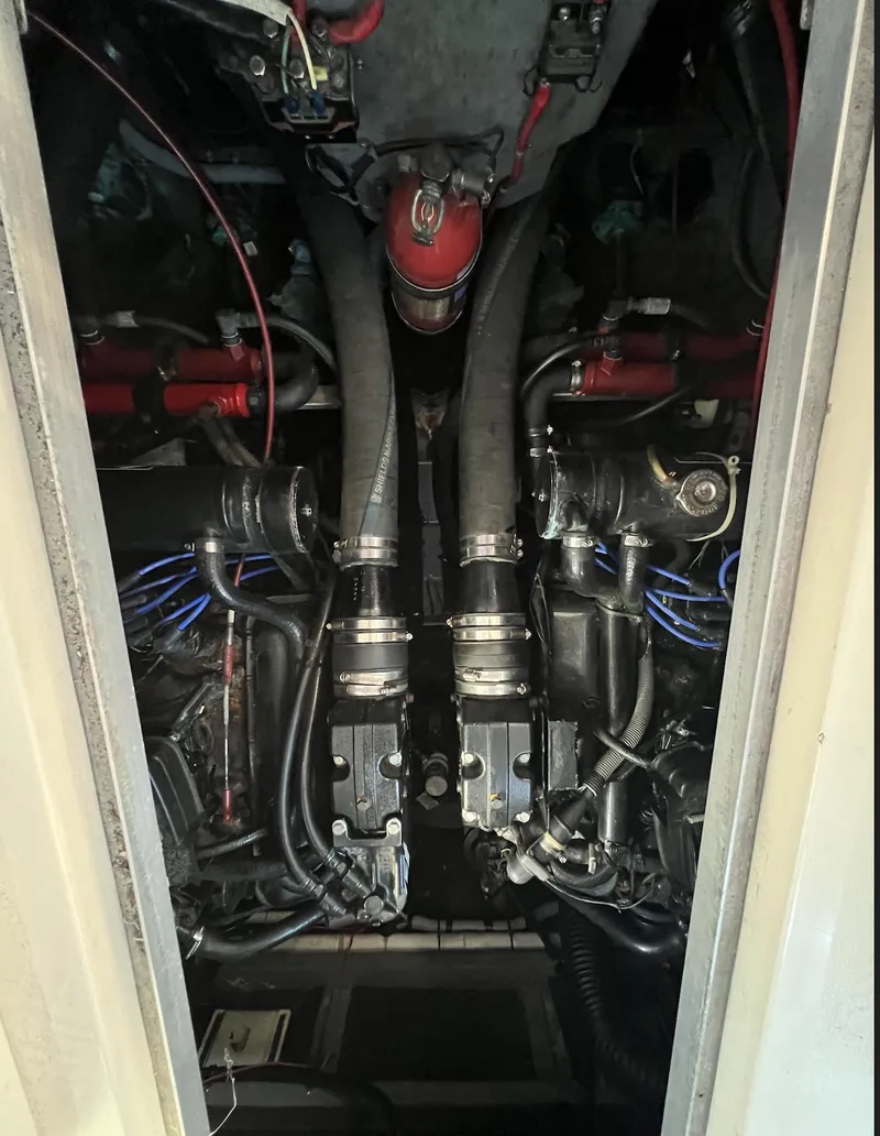 Slide: The Image of Engine compartment of 1986 Sea Ray 340 Express Cruiser, showcasing dual engines and components. - 34