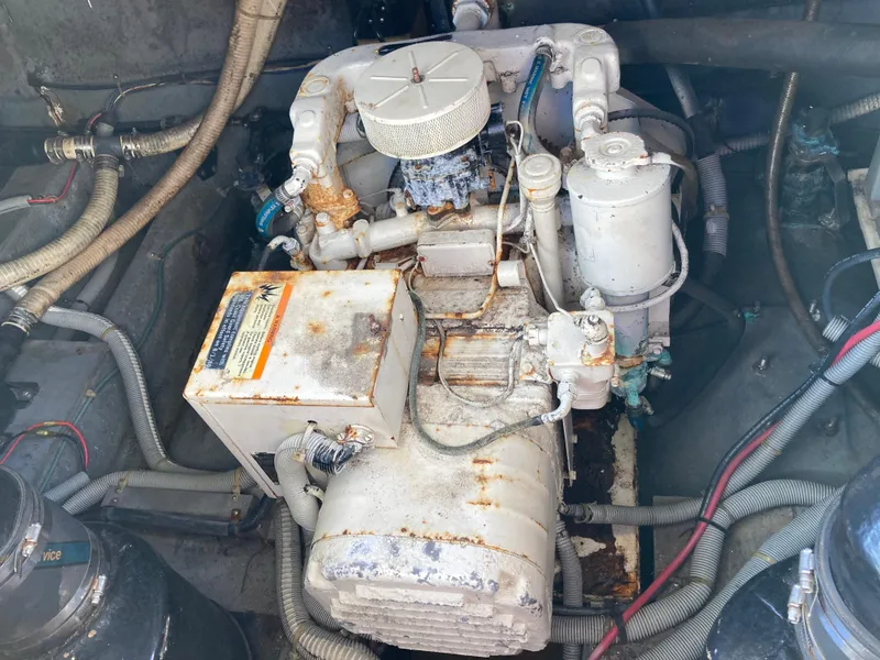 Slide: The Image of Engine compartment of 1986 Sea Ray 340 Express Cruiser, showing mechanical components and wiring. - 35