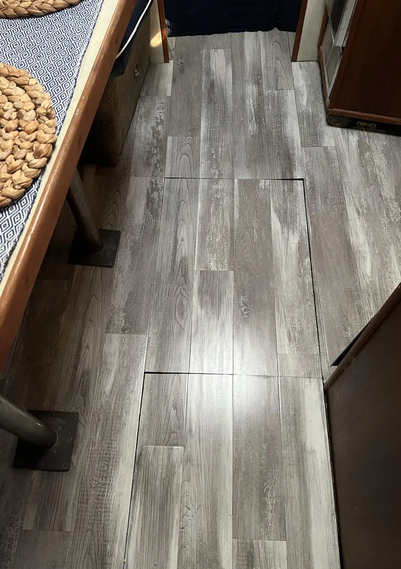 Slide: The Image of 1986 Sea Ray 340 Express Cruiser interior with wood-style flooring. - 38