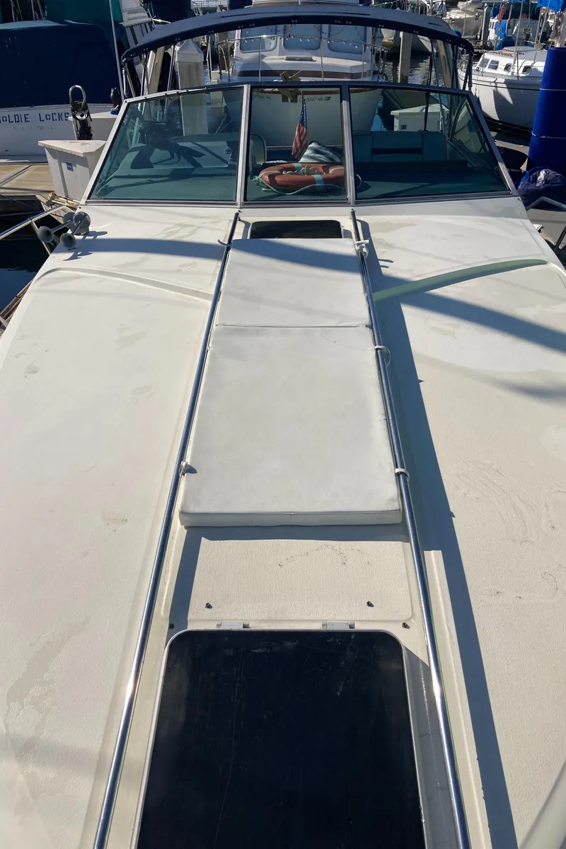 Slide: The Image of 1986 Sea Ray 340 Express Cruiser docked at marina, view of deck and windshield. - 43