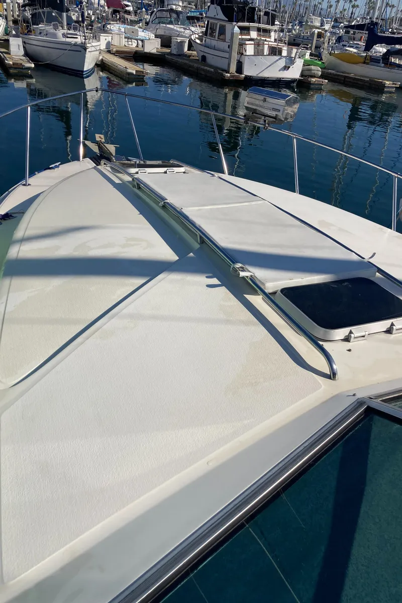 Slide: The Image of 1986 Sea Ray 340 Express Cruiser docked in marina. - 44