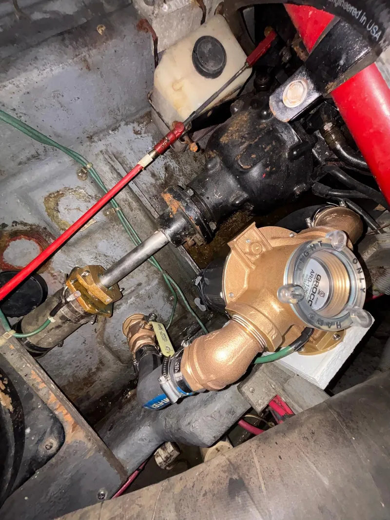Slide: The Image of Engine compartment of a 1986 Sea Ray 340 Express Cruiser, showcasing mechanical components and piping. - 48