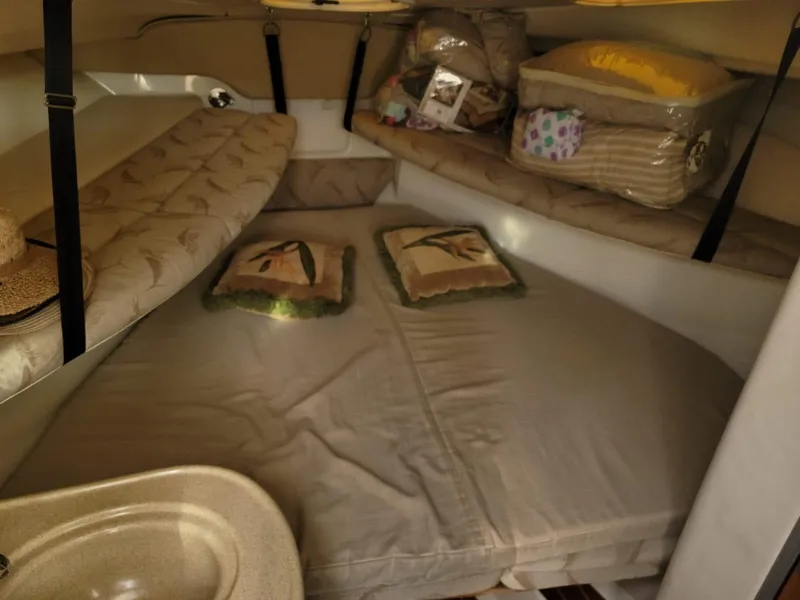 Slide: The Image of 2004 Hydra-Sports Vector 3300 VX cabin interior with cozy bedding and storage. - 12