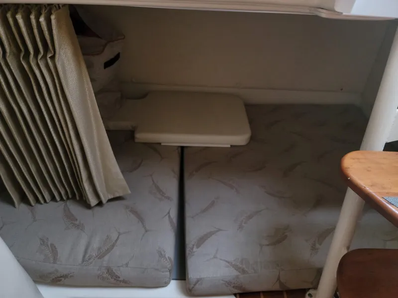 Slide: The Image of 2004 Hydra-Sports Vector 3300 VX cabin interior with cushioned seating and table. - 13