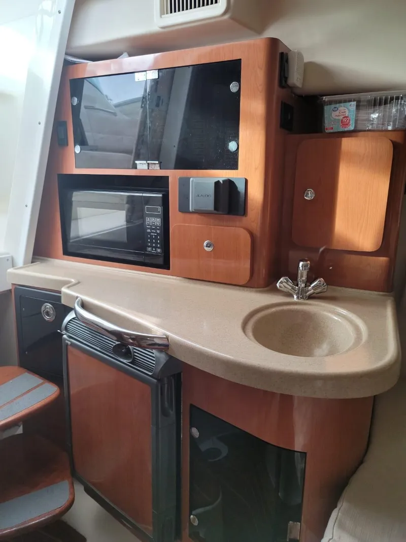 Slide: The Image of 2004 Hydra-Sports Vector 3300 VX cabin kitchen with sink, microwave, and storage. - 8
