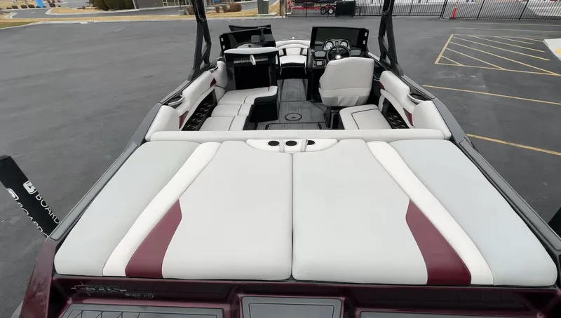 Slide: The Image of 2018 Axis Boats A22 interior with white and maroon seating, dashboard view. - 10